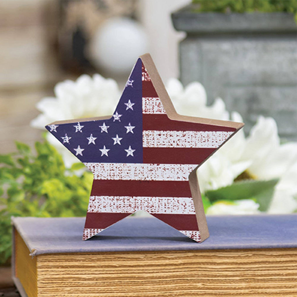 Star-shaped object with American flag design on a surface outdoors