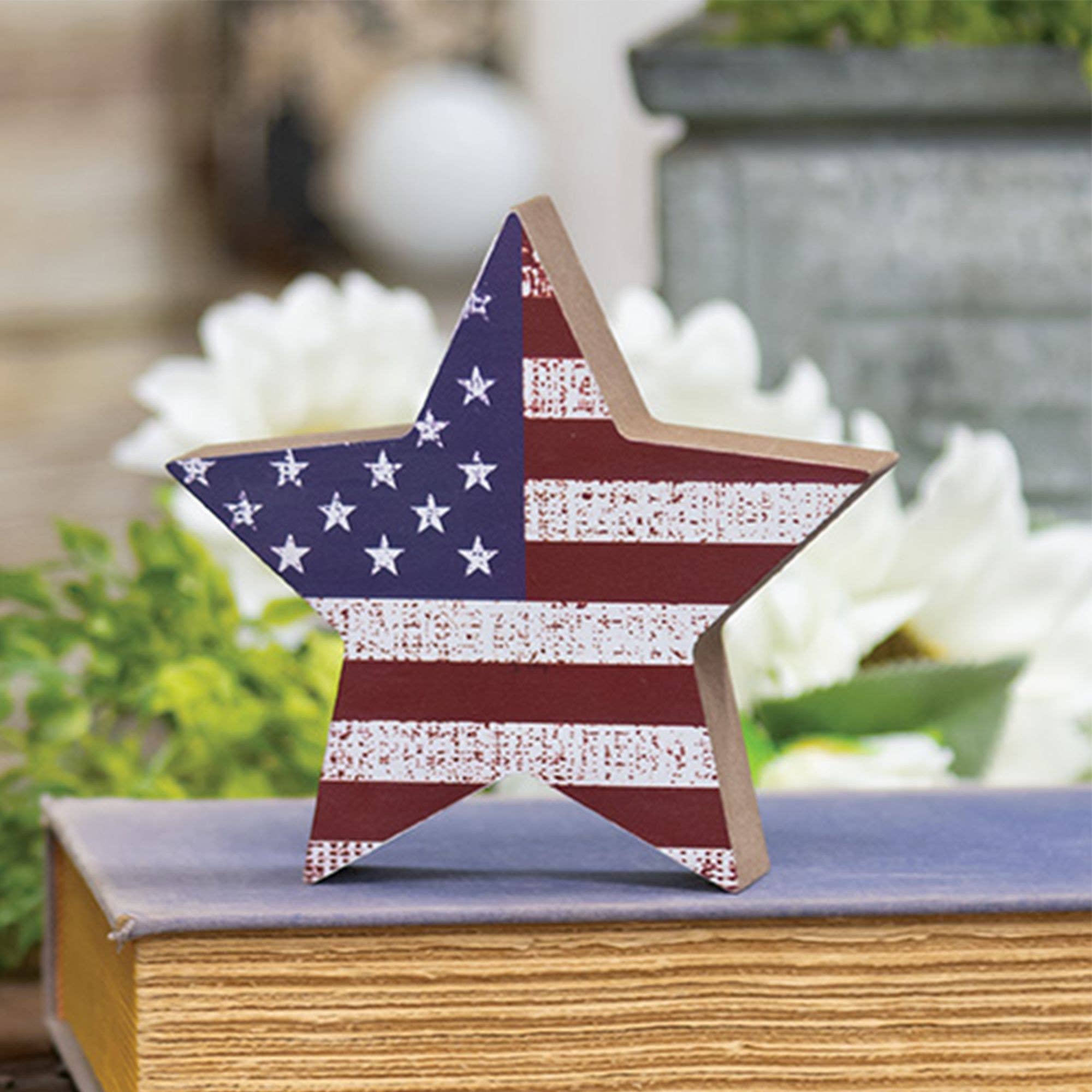 Star-shaped object with American flag design on a surface outdoors