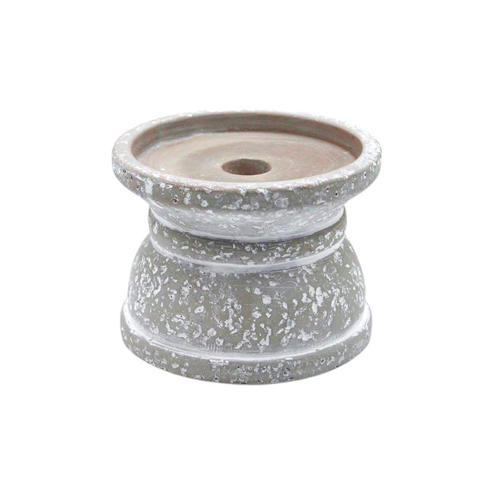 Ceramic pot with a textured finish on a white background