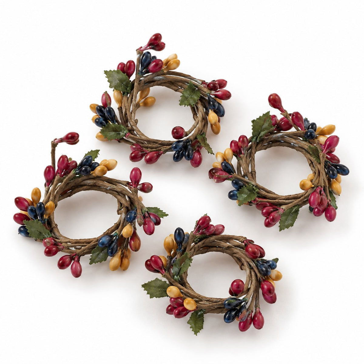 Four rustic grapevine wreaths decorated with red berries, yellow acorns, and green leaves, arranged on a white background.