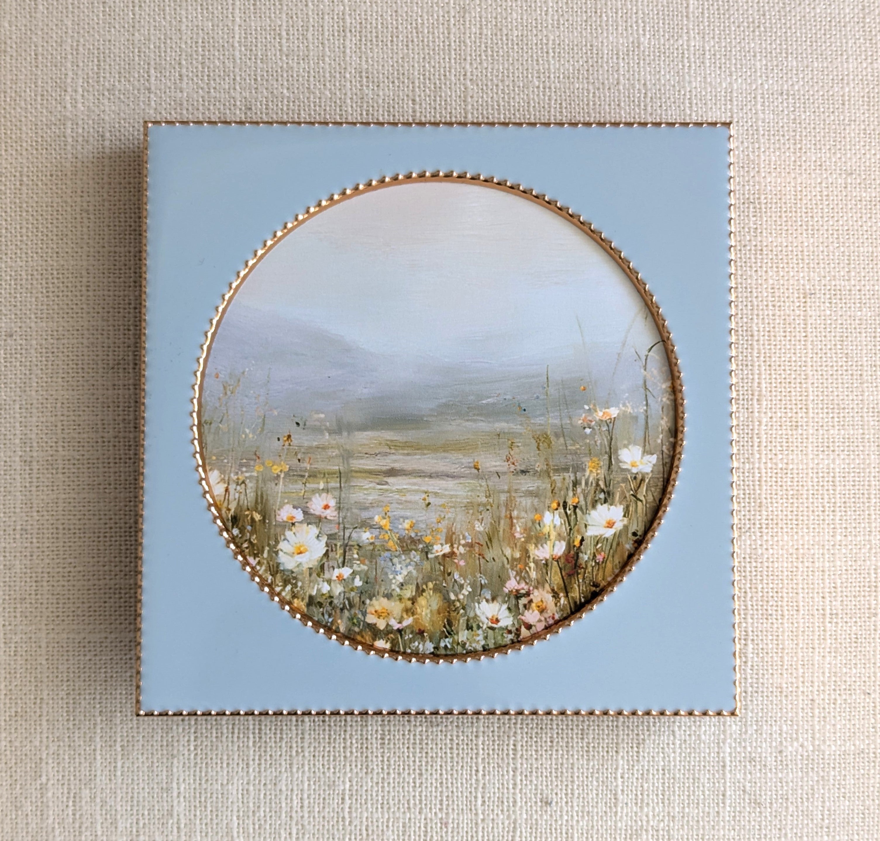 wildflower landscape art print in blue ceramic frame with round opening