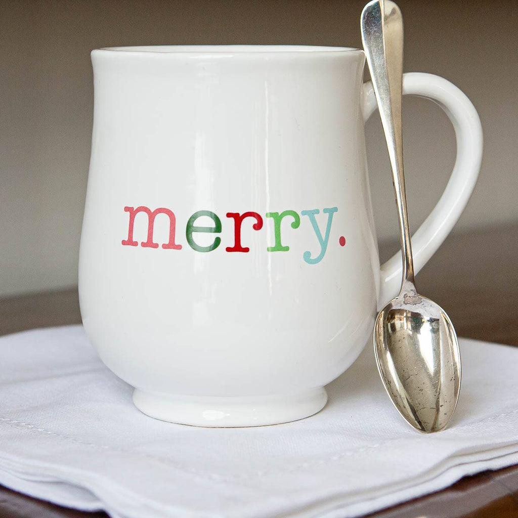 White mug with 'merry' text