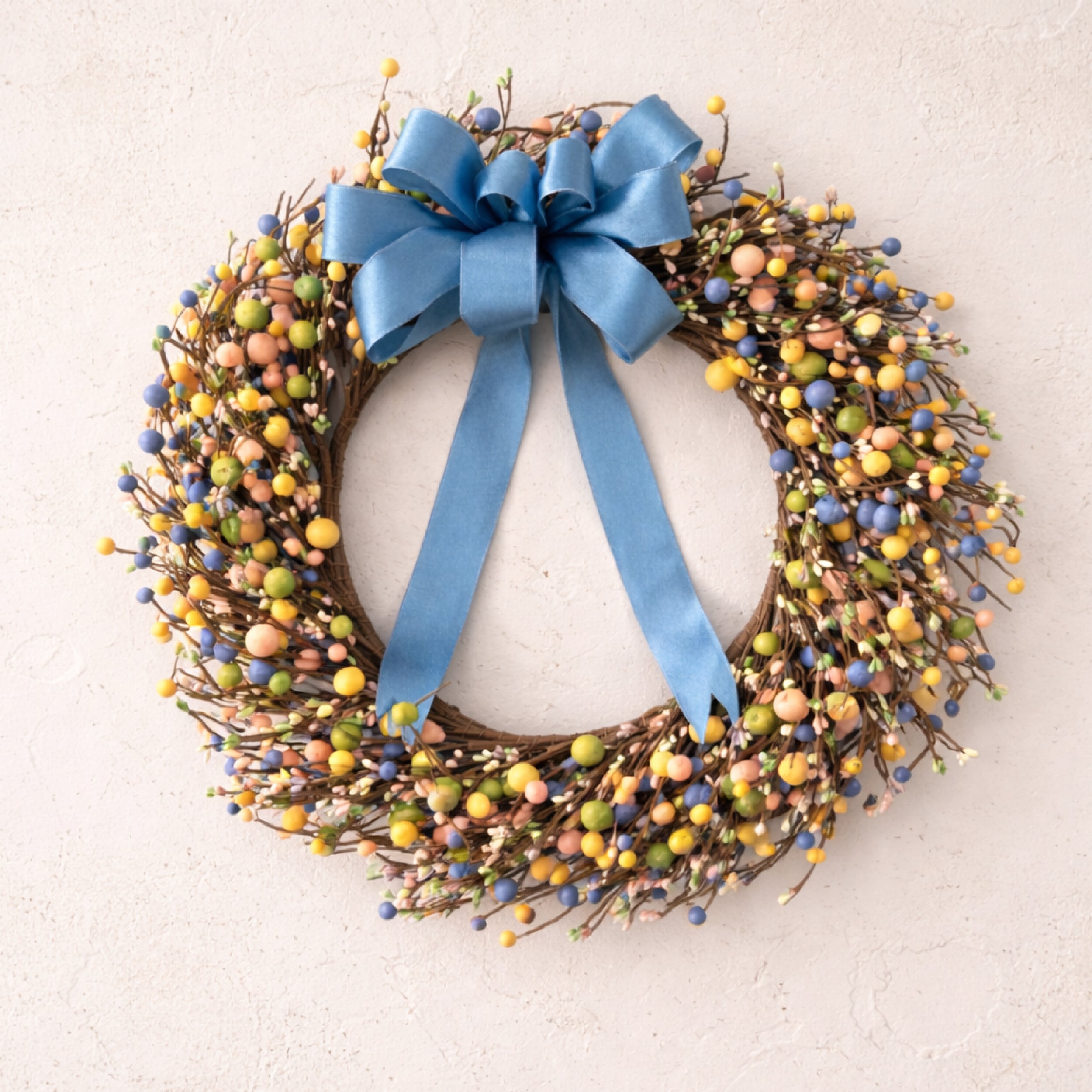 Spring Meadow Berry Wreath with pastel berries and blue satin bow on natural twig base, 19 inch diameter