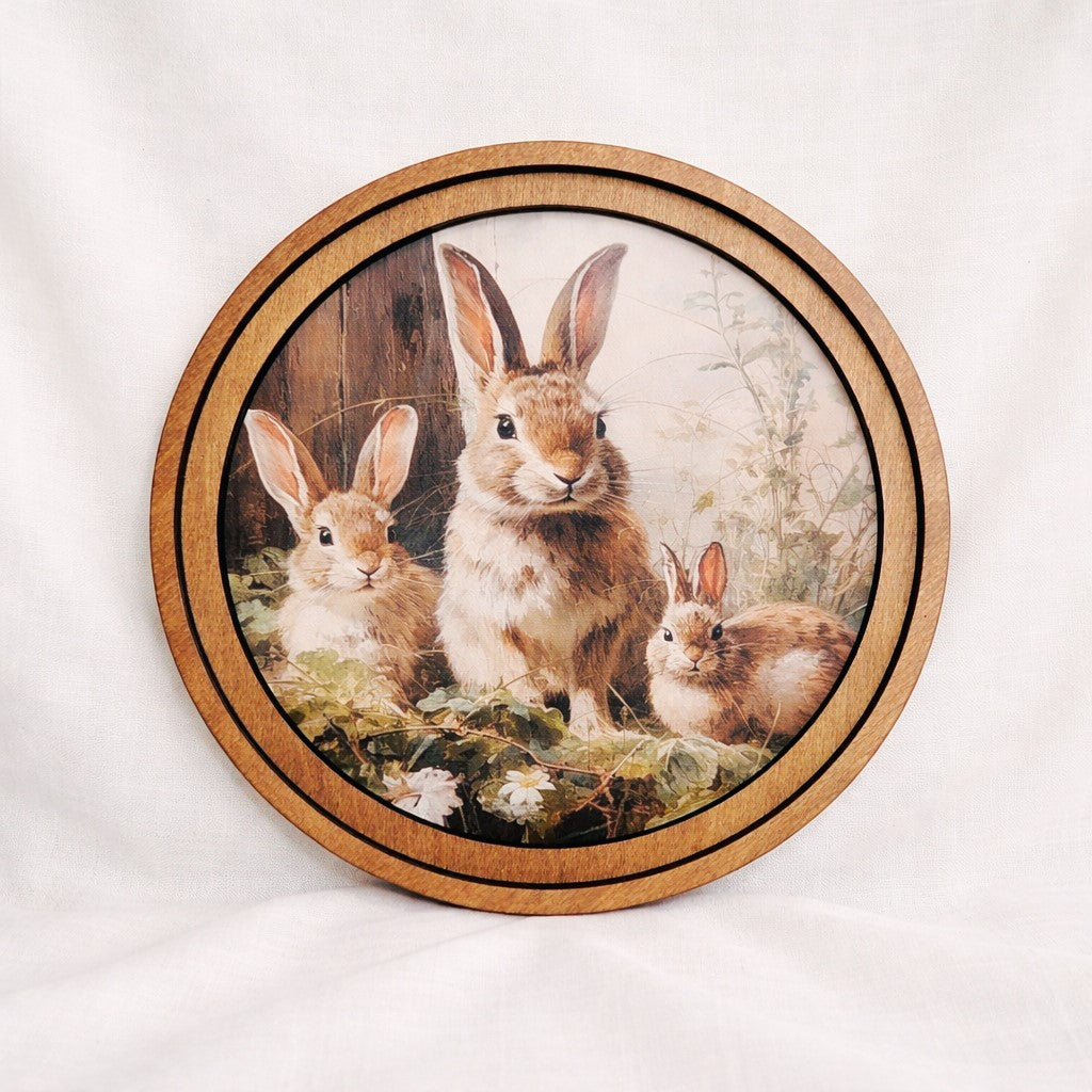 8 inch Woodland Bunnies Round Art - Round framed canvas artwork featuring sweet bunny family in soft storybook style with neutral Early American wood frame for spring nursery and farmhouse shelf decor