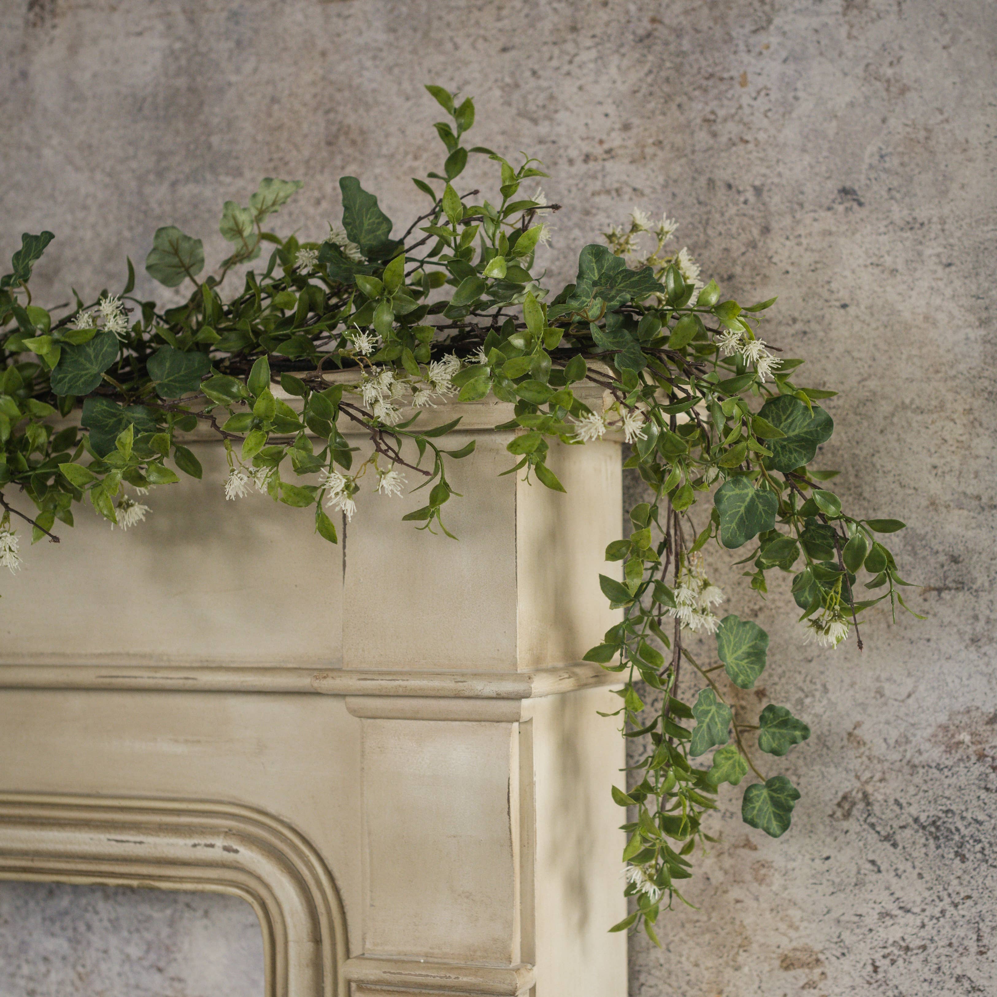 Ivy and Tea Leaf Garland, 60 inch artificial greenery with white flowers for mantel shelf and table decor.