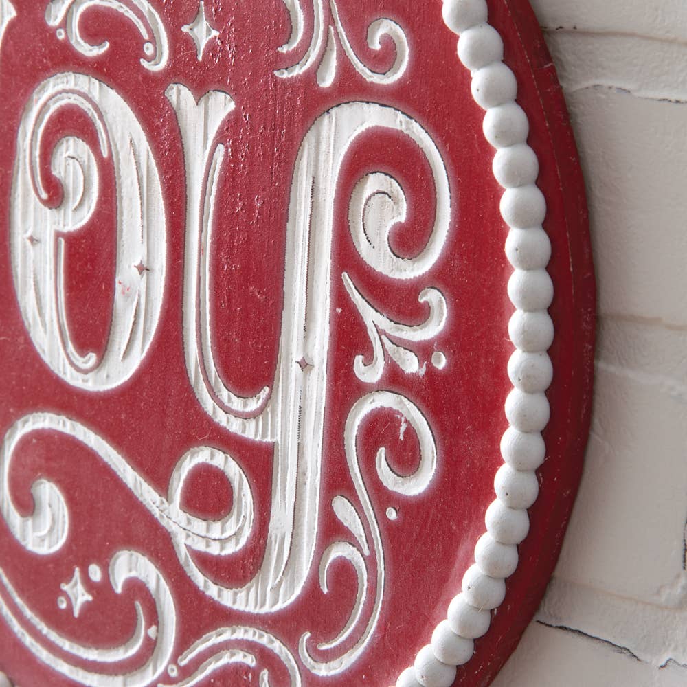 Joy Christmas wall sign with natural wood beads and jute tassel detail