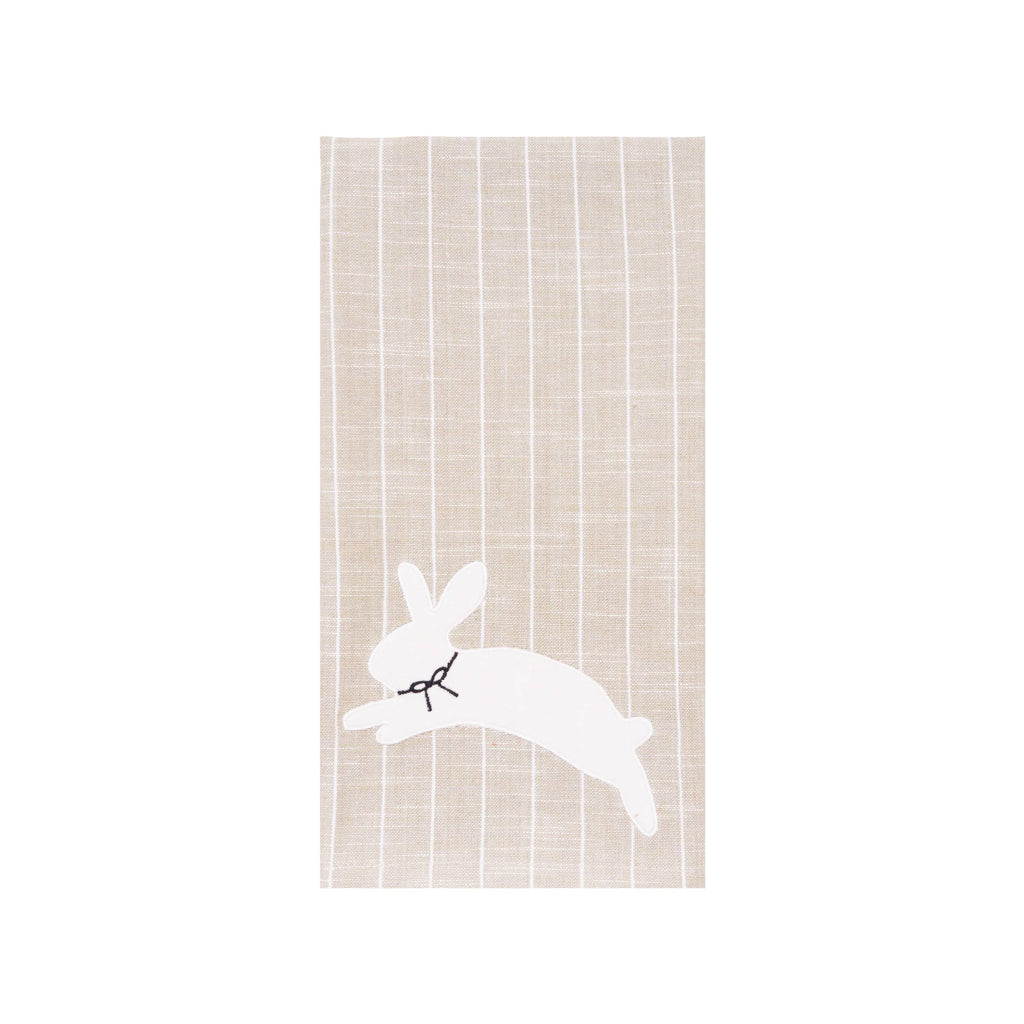 Cream colored kitchen towel featuring hopping rabbit graphic with botanical flowers and greenery in gray tones