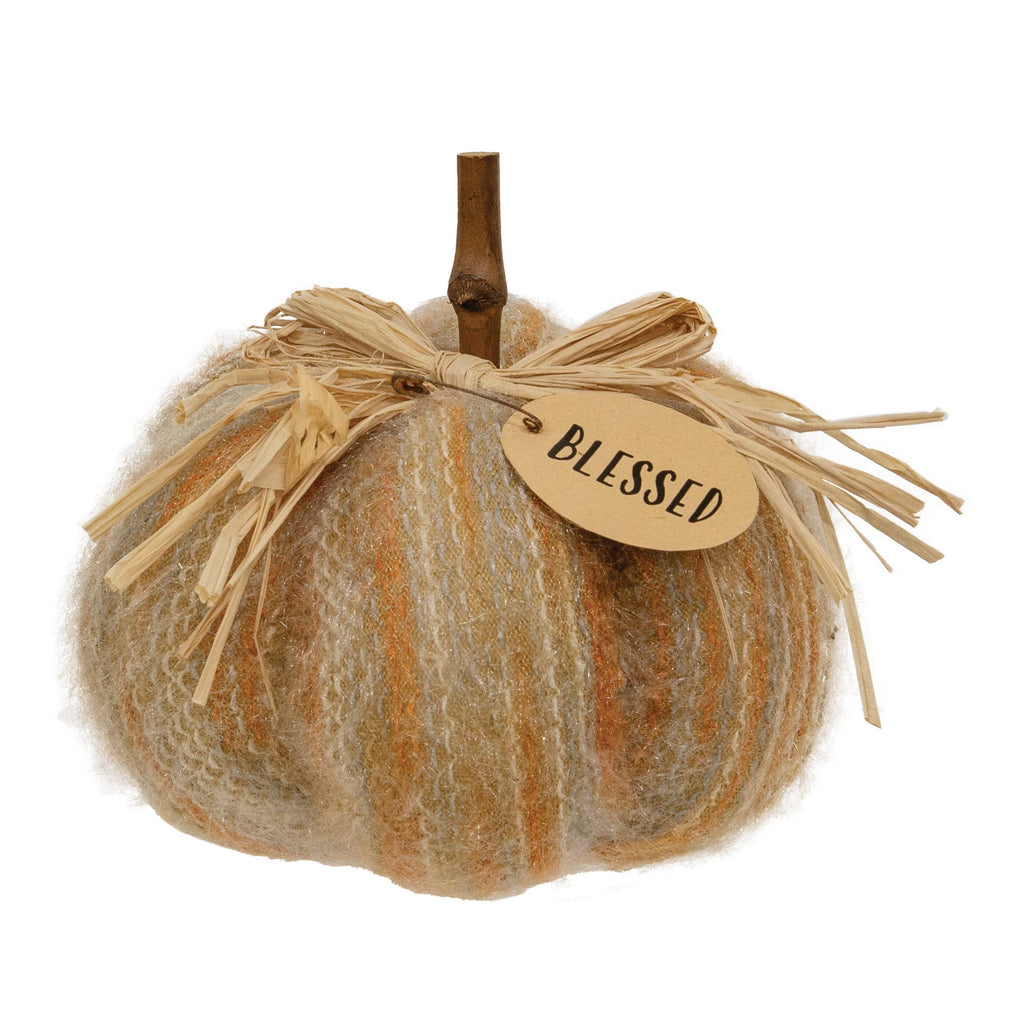Decorative pumpkin with a 'blessed' tag on a white background