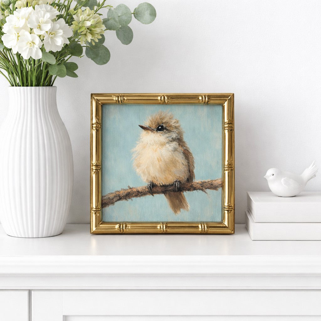 Framed artwork of a bird on a branch with a vase of flowers and books in the background.