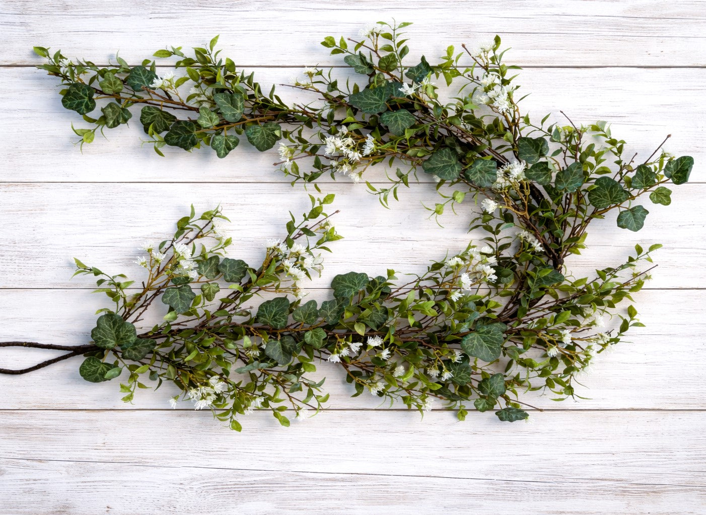 Ivy and Tea Leaf Garland, 60 inch artificial greenery with white flowers for mantel shelf and table decor.